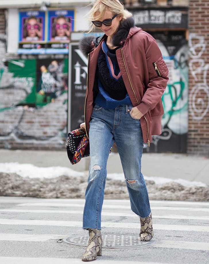 woman_wearing_snakeskin_boots_and_jeans